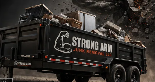 Strong Arm trailer with furniture and mixed junk loaded halfway or more